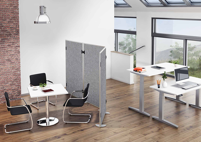 First slide – Arbeitsplatz mit motorischem Tisch, Sitzgruppe und Akustik-Stellwand